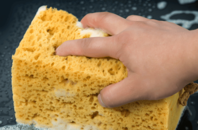 Scrubbing the helmet with sponge